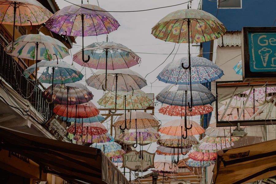 A canopy of brightly coloured umbrellas strung above a pedestrian street in Siem Reap