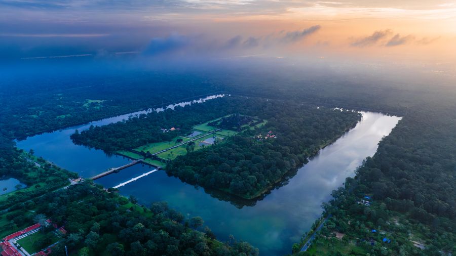 The Siem Reap River winding between tree-lined banks at sunrise